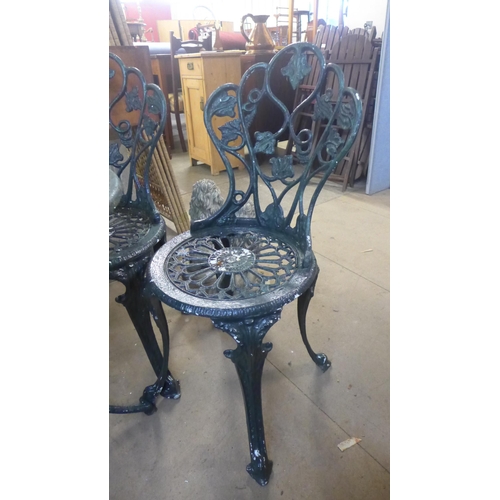 284 - A painted cast alloy garden table and four chairs