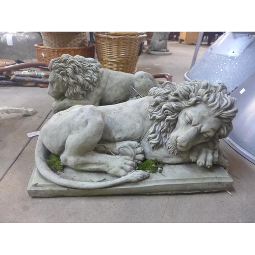 288 - A pair of concrete garden figures of recumbent lions