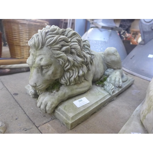 288 - A pair of concrete garden figures of recumbent lions