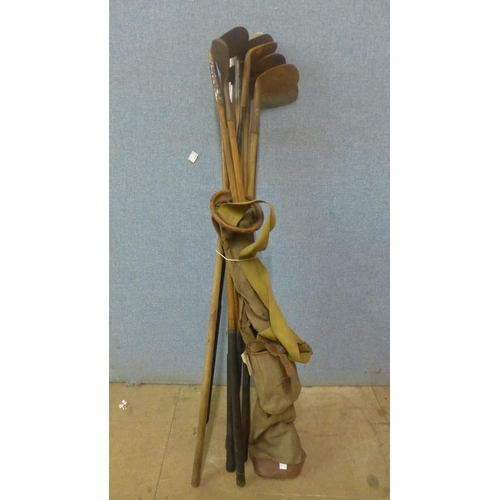 294 - Assorted vintage golf clubs, including seven hickory clubs