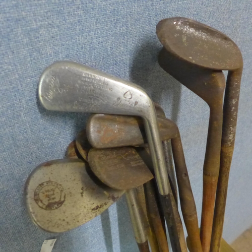 294 - Assorted vintage golf clubs, including seven hickory clubs