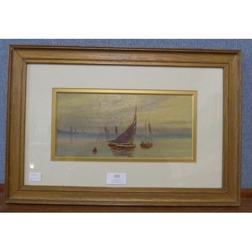 302 - English School, (19th Century), landscape with boats at sunset, oil on canvas laid on board, framed