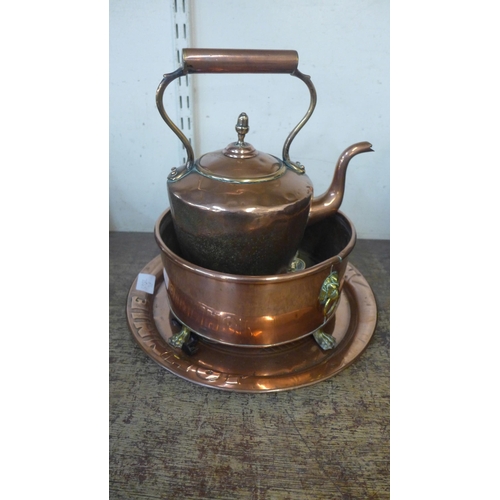 382 - A Victorian copper kettle, a bowl, a small charger and a brass trivet