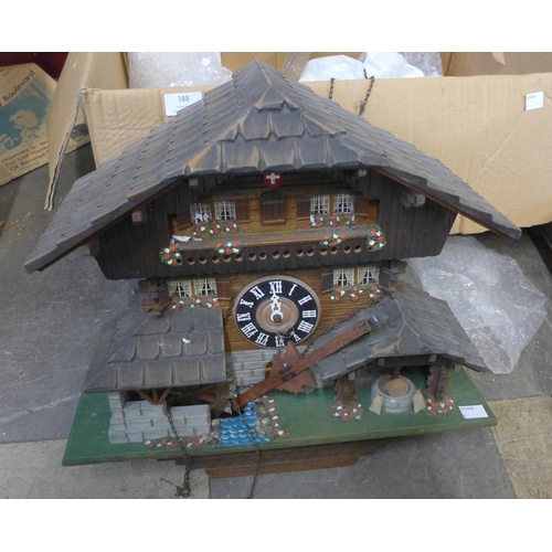 388 - A Swiss painted wooden cuckoo clock