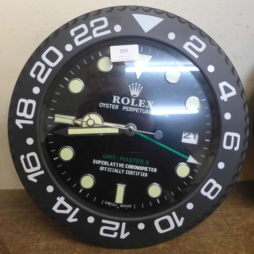 396 - A Rolex style dealer's display wall clock