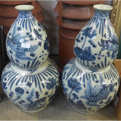 409 - A pair of Chinese blue and white porcelain double gourd shaped vases