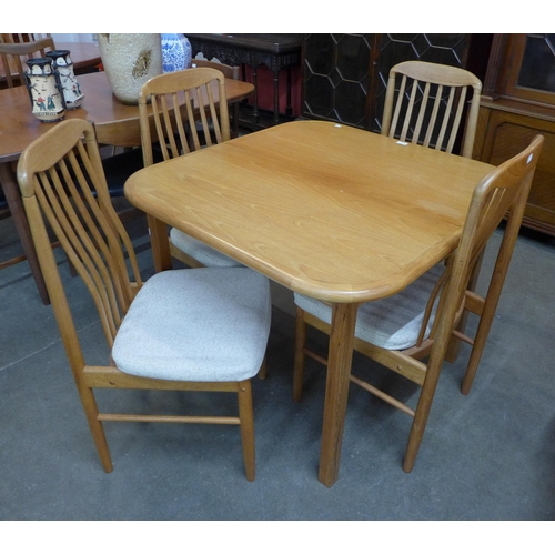 41 - A teak extending dining table and four chairs