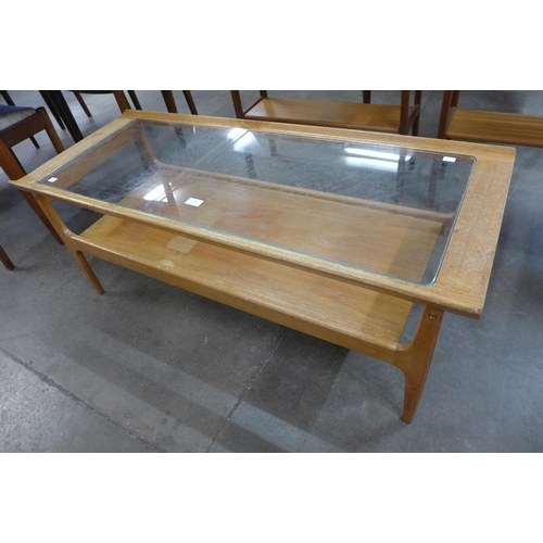 42 - A teak and glass topped rectangular coffee table