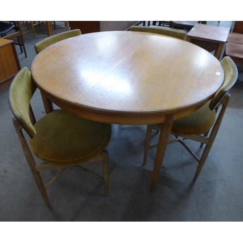 55 - A G-Plan Fresco teak circular extending dining table and four chairs