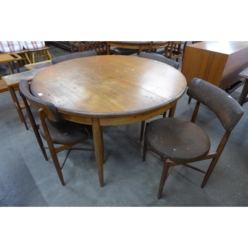 60 - A G-Plan Fresco teak circular extending dining table and four chairs