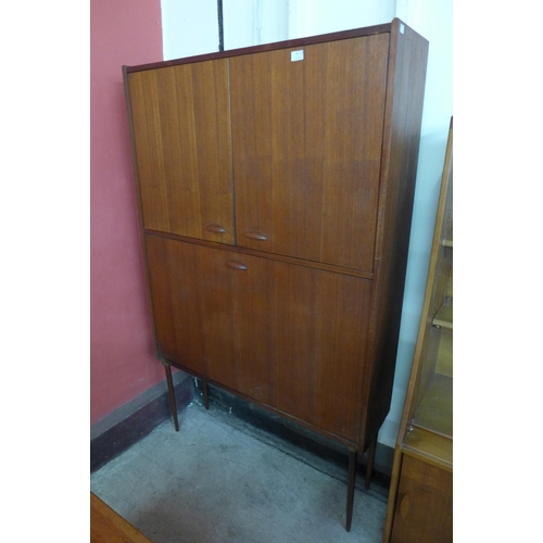 69 - A teak three door side cabinet