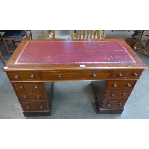 98 - A Victorian mahogany and red leather topped pedestal desk