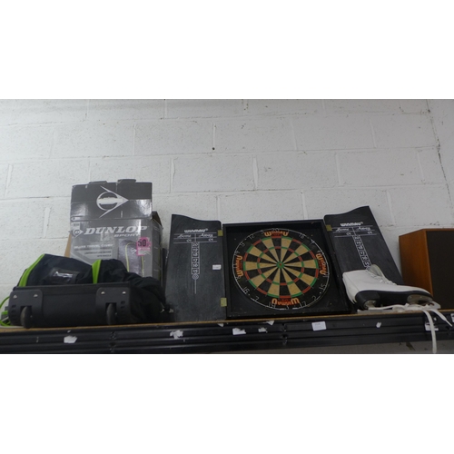 2124 - A Winmau dartboard in case, Dunlop holdall and pair of ice skates