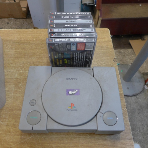 2175 - A Sony Playstation One console and controller with a quantity of games including Tomb Raider, Rayman... 