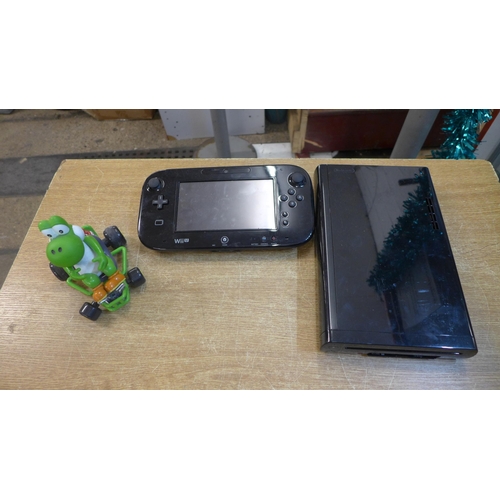 2176 - A Nintendo Wii U console with power cable and charger and a remote controlled Yoshi Mario Kart toy