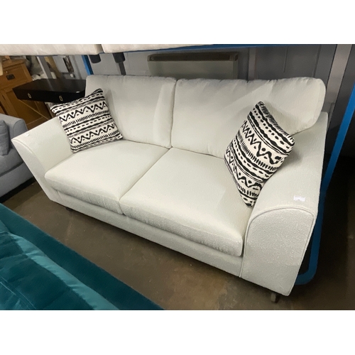 1493 - A white Teddy bear fabric upholstered three seater sofa with patterned scatter cushions