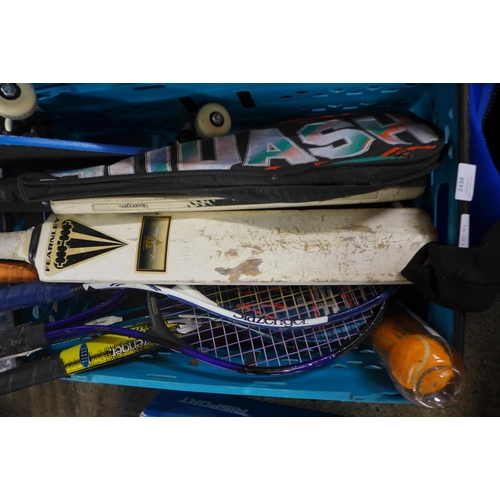 2438 - A quantity of sports equipment including cricket bats, squash and tennis racquets, a hockey stick, m... 