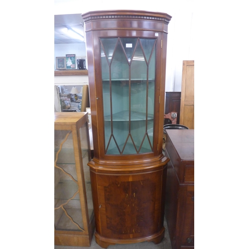 213 - A yew wood freestanding corner cabinet