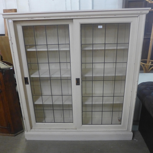 216 - A Victorian painted mahogany two door sliding bookcase