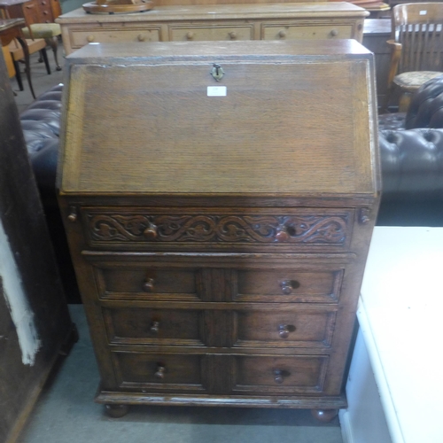 220 - A 17th Century style carved oak bureau