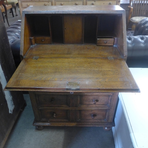 220 - A 17th Century style carved oak bureau