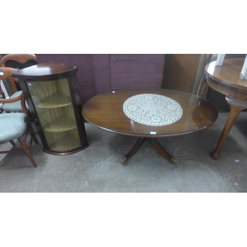 225 - An oval mahogany coffee table and a wall hanging corner cabinet