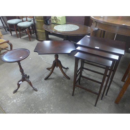 228 - A mahogany nest of tables, an occasional table and a tripod wine table