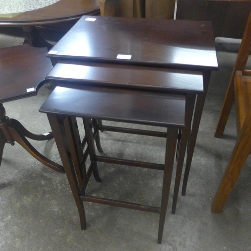 228 - A mahogany nest of tables, an occasional table and a tripod wine table