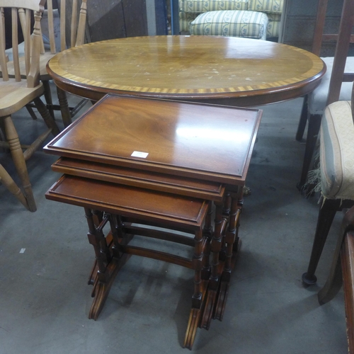 235 - A Regency style mahogany oval coffee table and a nest of tables