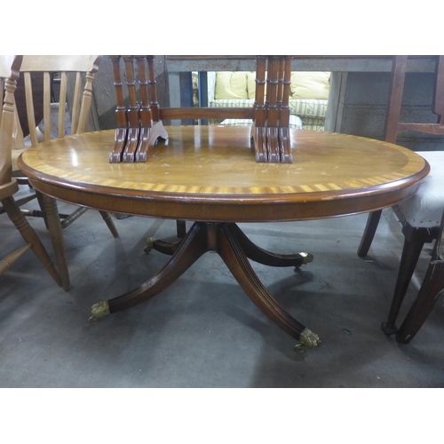 235 - A Regency style mahogany oval coffee table and a nest of tables