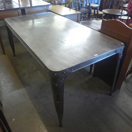 243 - A large industrial style polished steel kitchen table