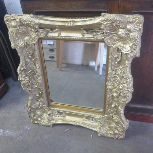 252 - A Rococo style gilt framed mirror