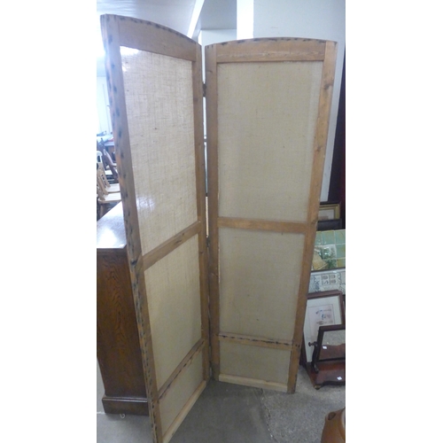 255 - A pair of pine two panel folding dressing screens