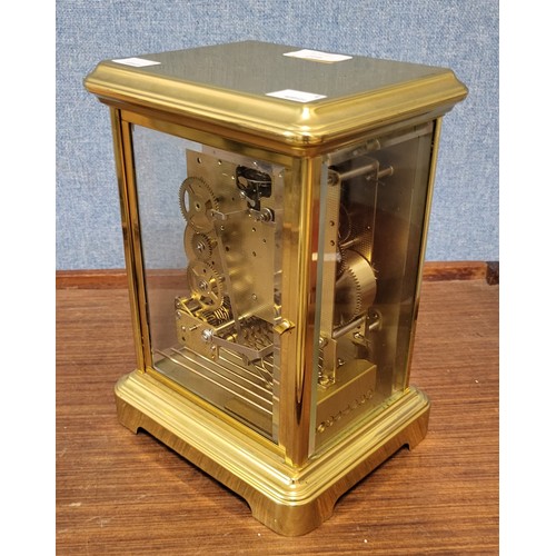 412 - A Rapport of London brass and four sided glass mantel clock