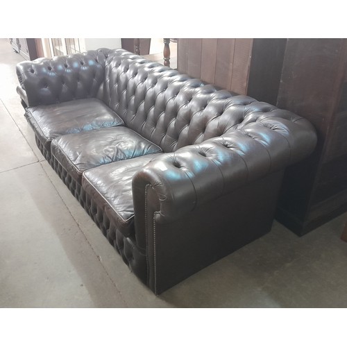 126 - A chestnut brown leather Chesterfield settee