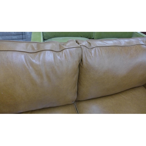 1303 - A tan vintage leather two and a half seater sofa with studwork, RRP £2850 * this lot is subject to V... 