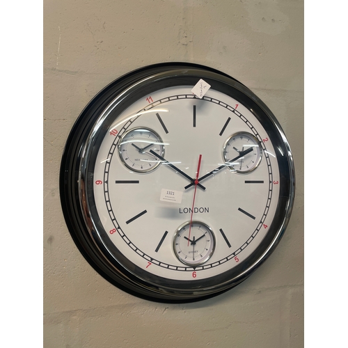 1321 - A black multi dial clock with convex face