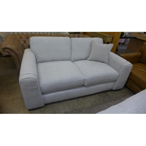 1386 - An ivory upholstered three seater sofa RRP £1099