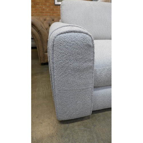 1386 - An ivory upholstered three seater sofa RRP £1099