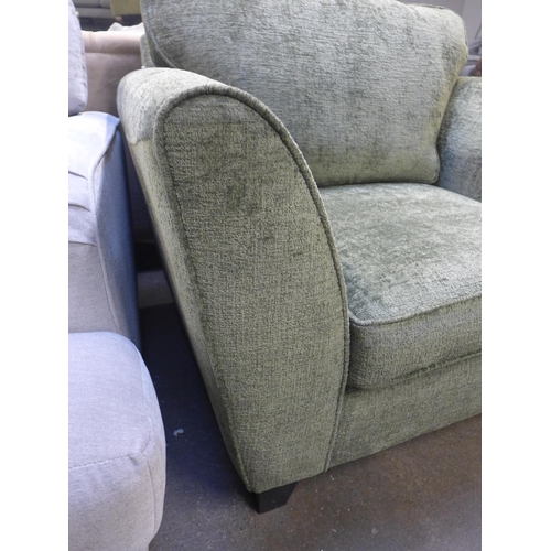 1400 - A moss green textured velvet upholstered oversized armchair