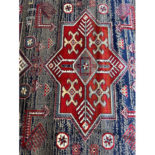 1427 - A blue ground full pile Cashmere rug with Aztec design (170cm x 120cm)