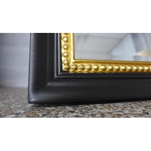 1462 - A black and gold beaded overmantel mirror
