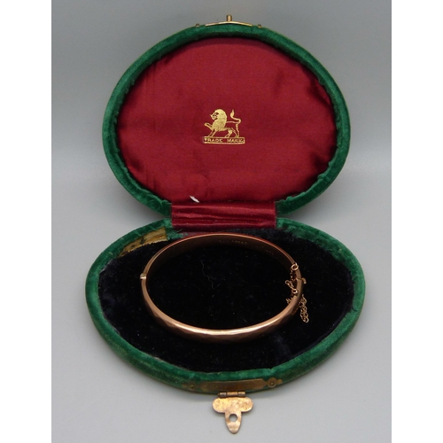 1002 - A 9ct gold bangle, marked 'wax filled', 10.5g