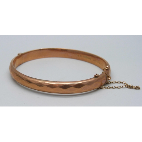 1002 - A 9ct gold bangle, marked 'wax filled', 10.5g