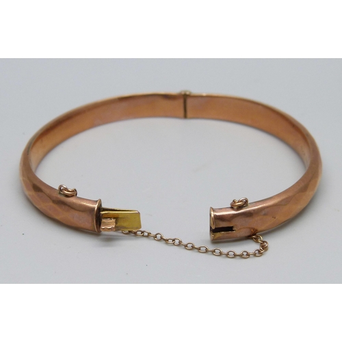 1002 - A 9ct gold bangle, marked 'wax filled', 10.5g