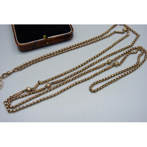 1008 - A yellow metal guard chain, one link marked 9ct, with a 9ct gold dog clip and a 9ct gold triskelion ... 