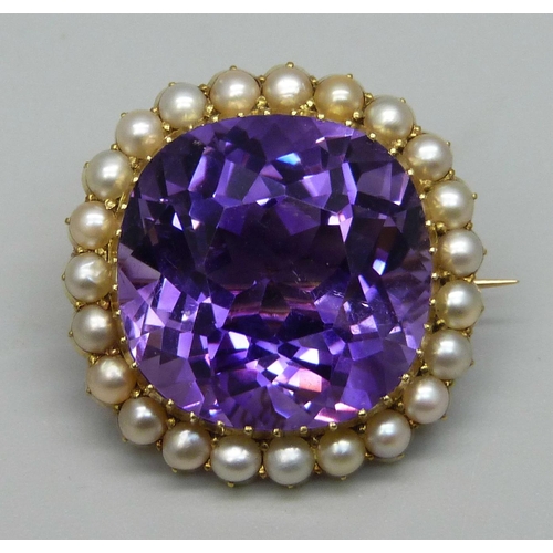 1009 - A 15ct gold brooch set with a cushion cut amethyst and seed pearl border, 11.7g, amethyst approximat... 