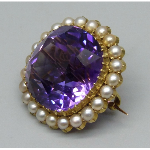 1009 - A 15ct gold brooch set with a cushion cut amethyst and seed pearl border, 11.7g, amethyst approximat... 