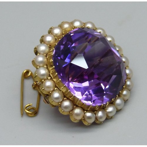 1009 - A 15ct gold brooch set with a cushion cut amethyst and seed pearl border, 11.7g, amethyst approximat... 