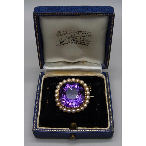 1009 - A 15ct gold brooch set with a cushion cut amethyst and seed pearl border, 11.7g, amethyst approximat... 